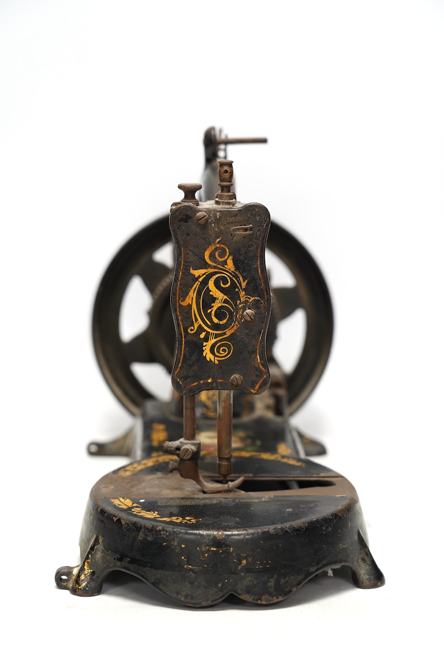 An unmarked late 19th century swan neck sewing machine, with cast iron base and gilt and floral decoration. Condition - fair